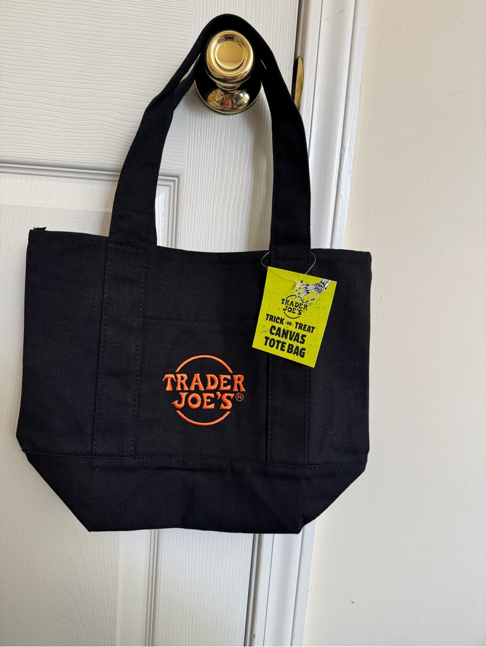 Trader Joe’s Black Trick or Treat Small Canvas Tote Bag with Orange Logo.